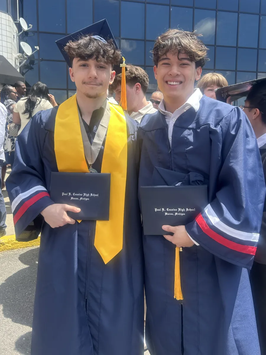 Kaden and Rami in caps and gowns at their high school graduation